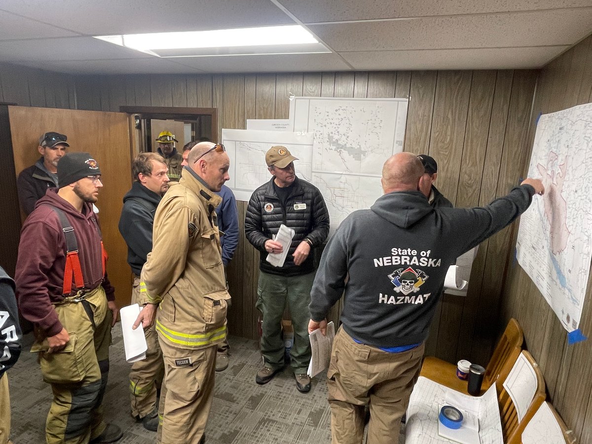 Firefighters Study Maps During Morning Briefing in Oshk...