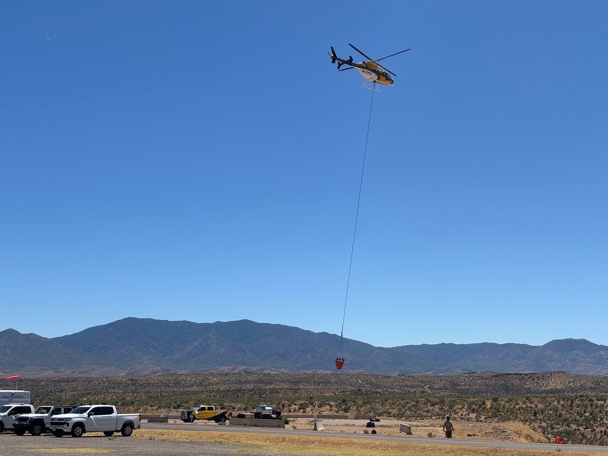 Helicopter with bucket lifting off 061926