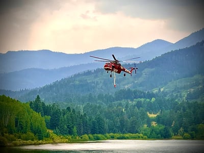 A Sikorsky Skycrane dips out of Lake Isabel to support the Aspen Acres