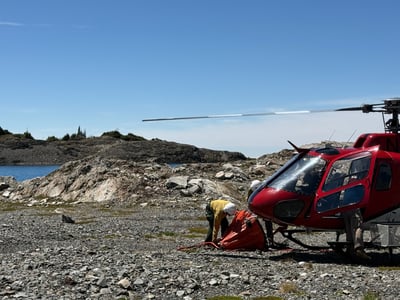 Helicopter prepares a bucket for dipping water