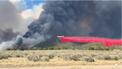 Iron Fire 2026 - Airplane drops red fire retardant on f...