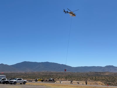 Helicopter with bucket lifting off 061926