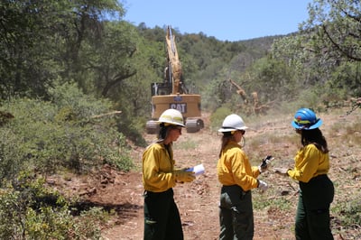 Resource advisors working with heavy equipment